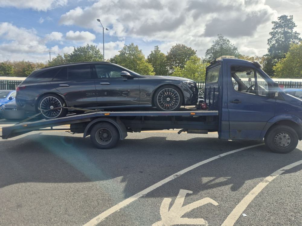 Estate car loaded on a JXR recovery truck